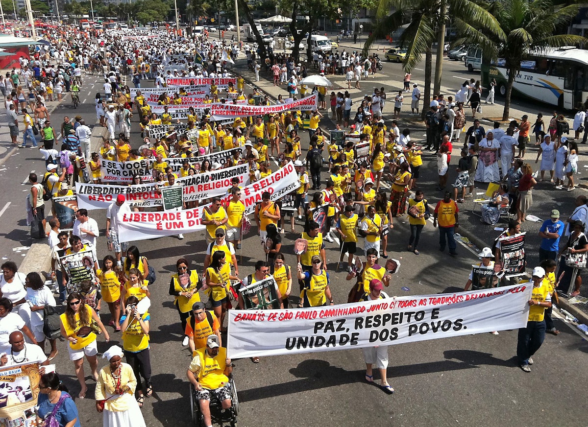 25,000 marchers took part in Rio's Religious Freedom Walk on 18 September 2011. Brazilian Baha'is are seen here carrying a banner which reads, "Peace, Respect and Unity of Peoples." 1,000 yellow vests bearing the slogan, "Today, we are followers of all religions" were distributed and worn by people of all faiths at the rally.