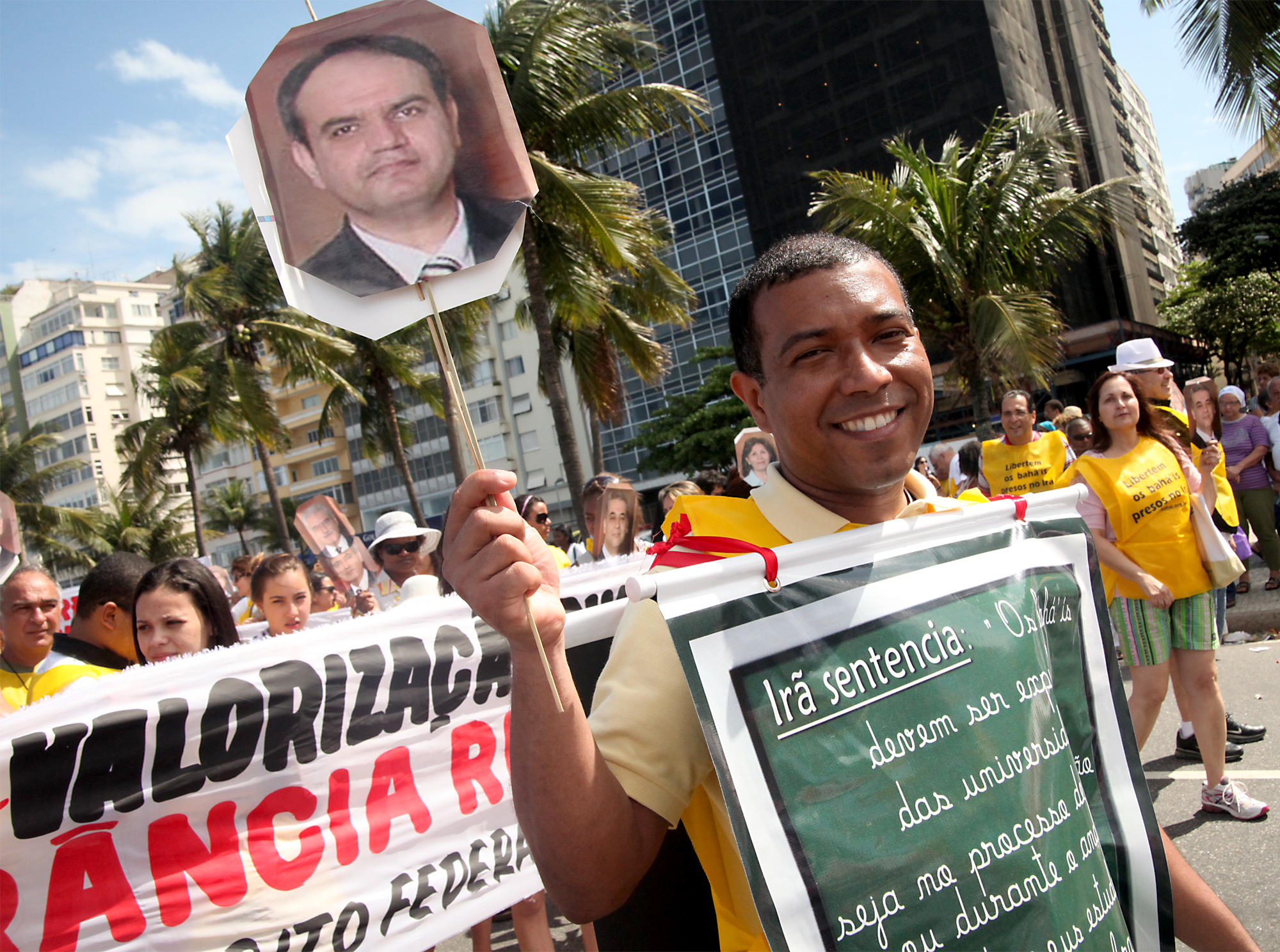 A participant at Rio's Religious Freedom Walk – held on 18 September 2011 – carries a placard depicting Mr. Vahid Tizfahm, one of Iran's seven imprisoned Baha'i leaders.