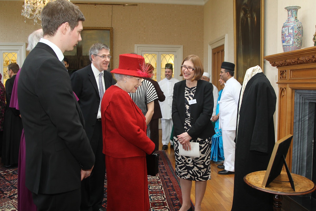 Her Majesty Queen Elizabeth II is met by a delegation of British Baha'is at a special multifaith gathering to mark her Diamond Jubilee. Invited to display a treasured object from their faith, the Baha'i community exhibited a robe of 'Abdu'l-Baha and a framed calligraphic rendering of words from His first ever public speech, given in London in 1911.