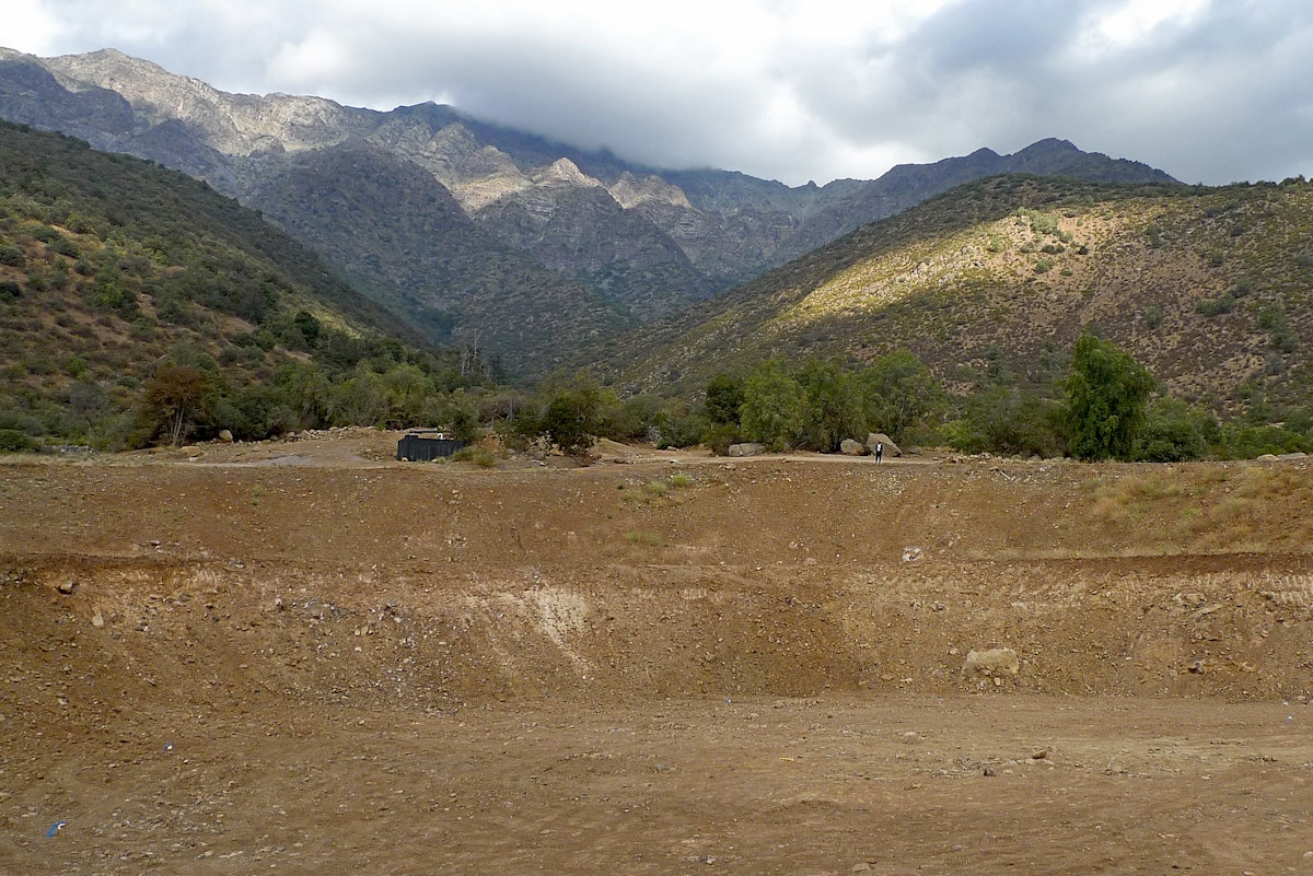 The beautiful location of the site of the Baha'i House of Worship for Chile, in the hills of Peñalolén, Santiago, at the foot of the Andes. In the foreground can be seen the excavation and grading work for the House of Worship's foundation and plaza which has been completed ahead of schedule.