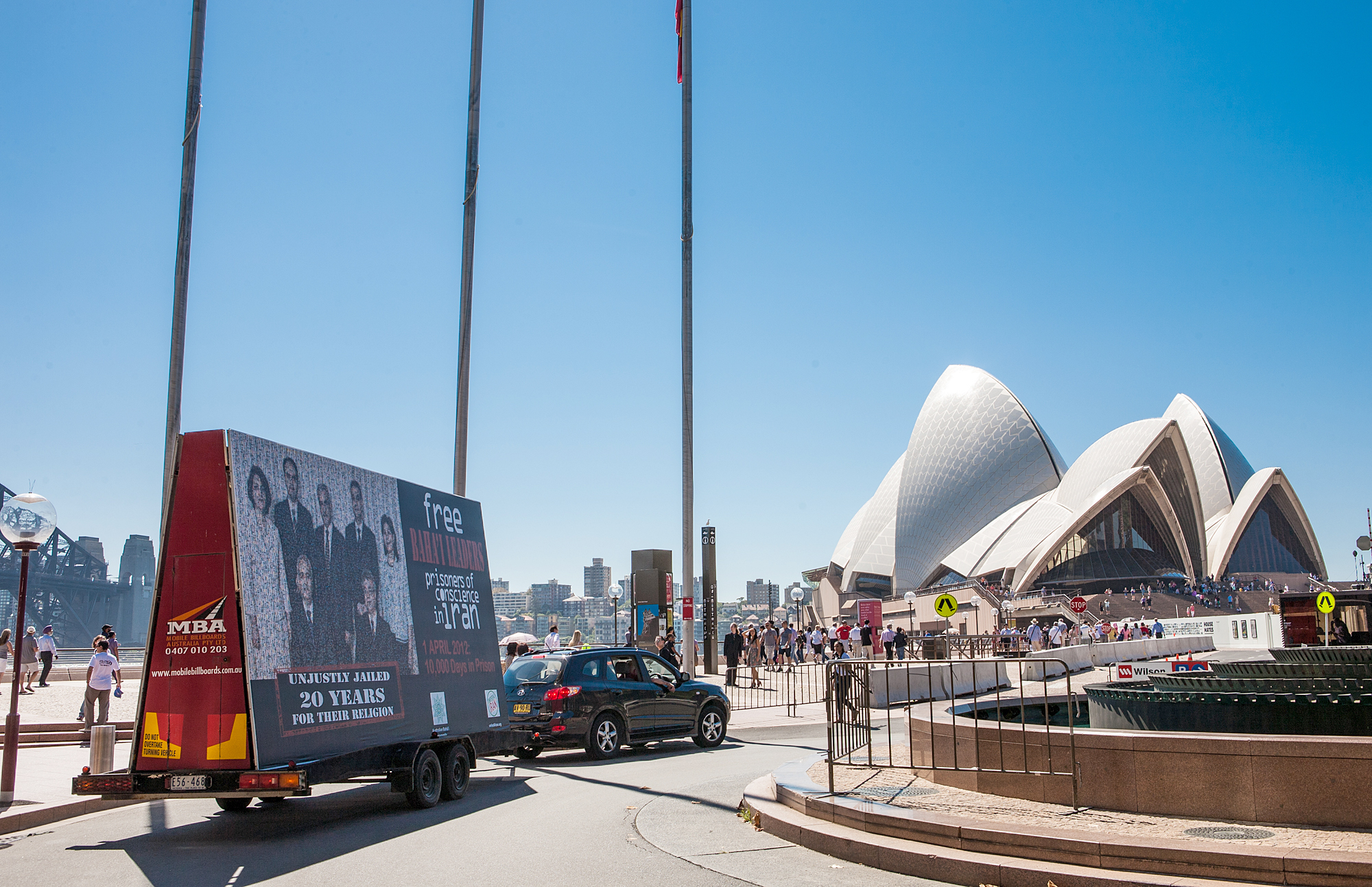 Sydney's famous opera house in Australia provides the backdrop for a mobile billboard depicting Iran's seven imprisoned Baha'i leaders, on Sunday 1 April.