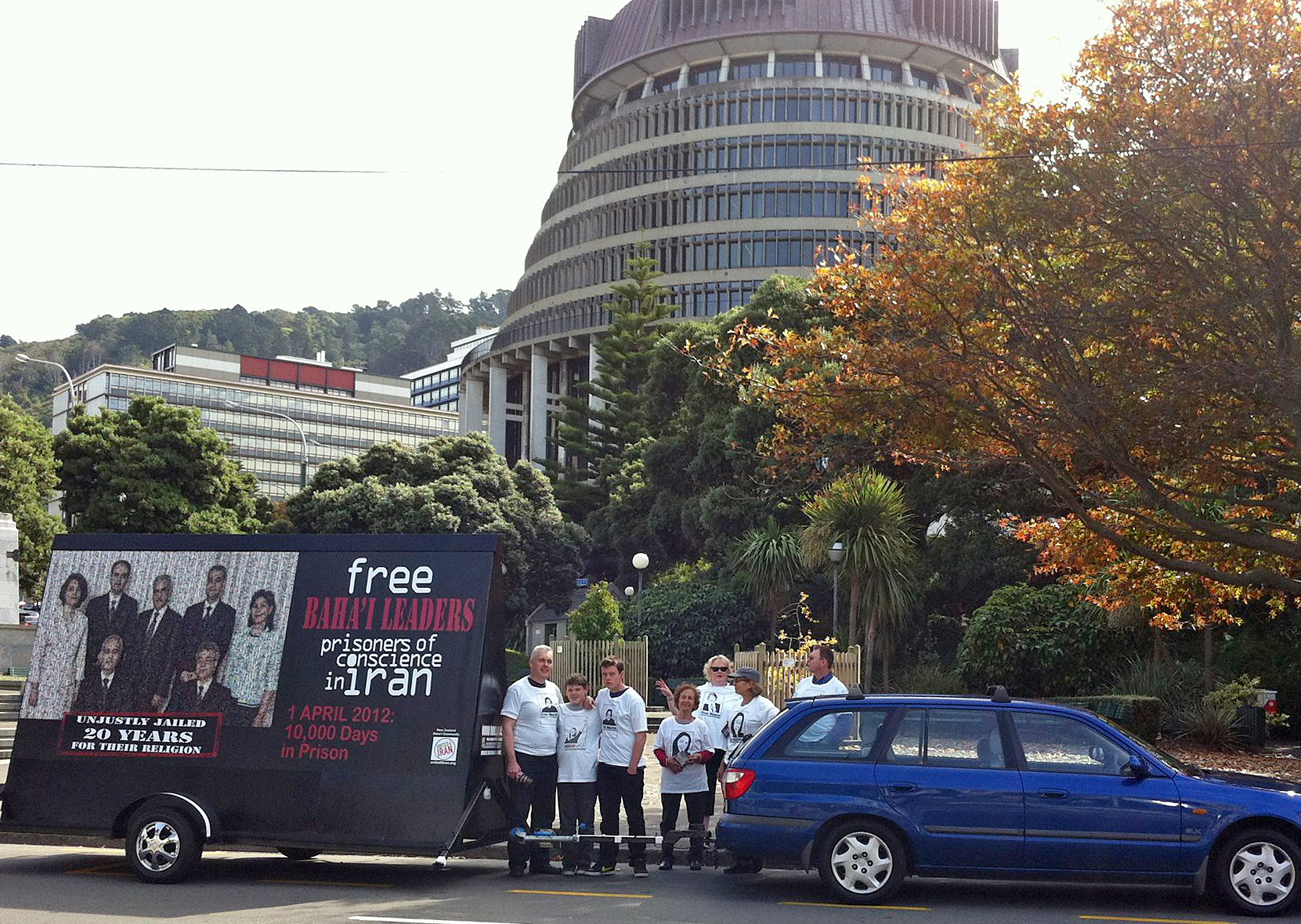 United4Iran supporters with their mobile billboard depicting Iran's seven imprisoned Baha'i leaders in front of New Zealand's Parliament House in Wellington, on Sunday 1 April.