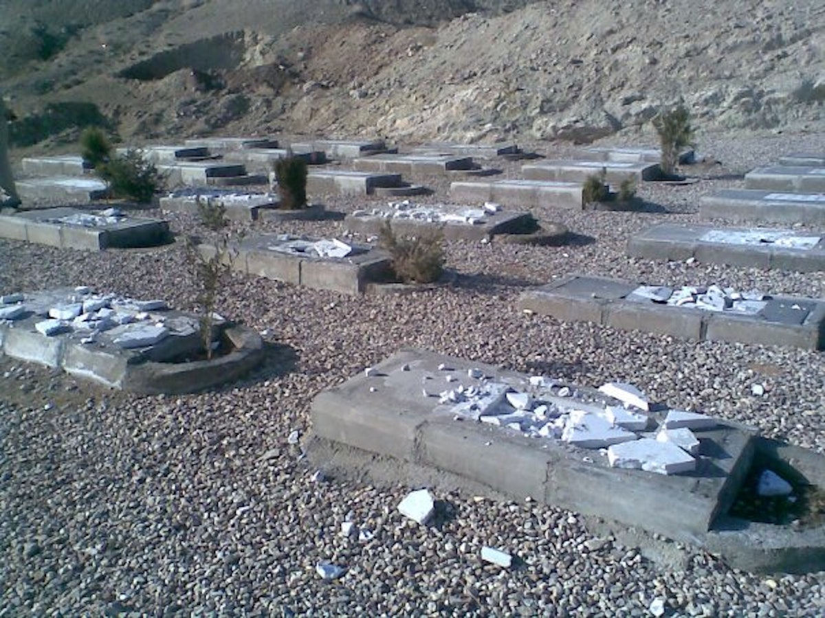 The Semnan Baha'i cemetery after it was vandalized in February 2009. Approximately 50 gravestones were demolished and the mortuary building was set on fire.