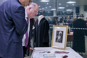 Eric Pickles MP, Secretary of State for Communities and Local Government– pictured right – examines personal and historical items associated with ‘Abdu’l-Baha at a reception hosted by the British government for the Baha’i community, 28 November 2012.