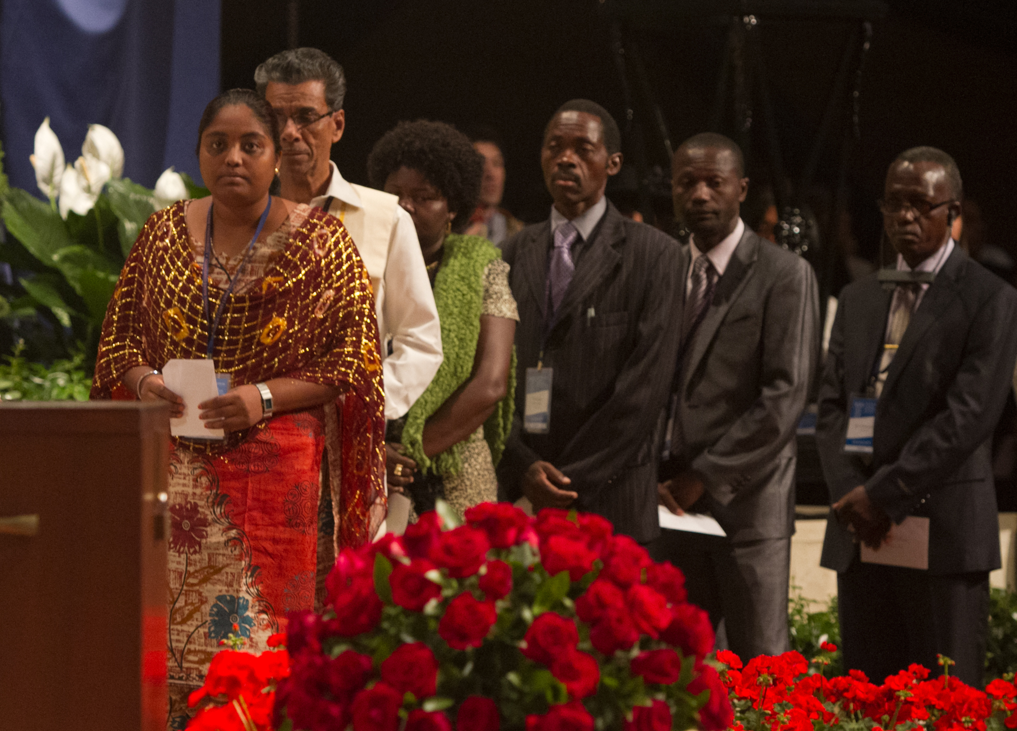 After filling out their ballots, delegates arrived at the stage in country groups to deposit their votes in a simple wooden box.