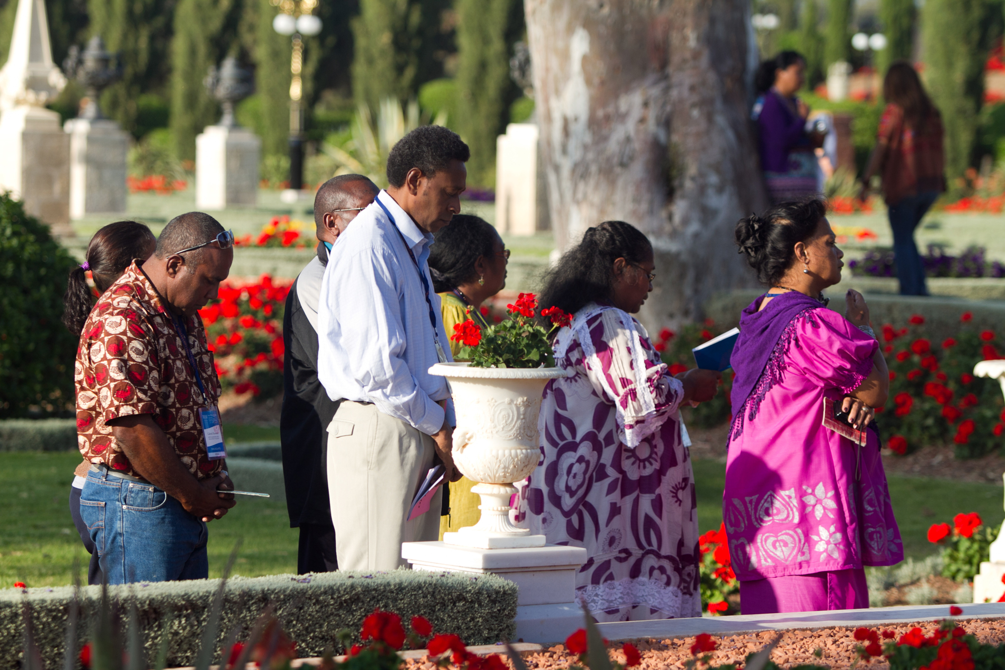 Representatives of National Spiritual Assemblies pray in the gardens outside of the Shrine of Baha'u'llah near Acre.