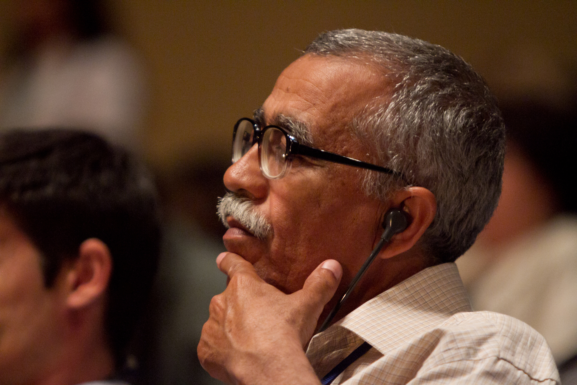 A delegate listens intently to the deliberations at the 11th International Baha'i Convention.