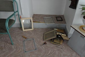 Iranian government agents confiscated photographs, Baha’i books, CDs, and computers during a raid on 14 homes in Abadeh, Iran, on 13 October 2013. Shown here are broken picture frames in a Baha’i home after the raid.