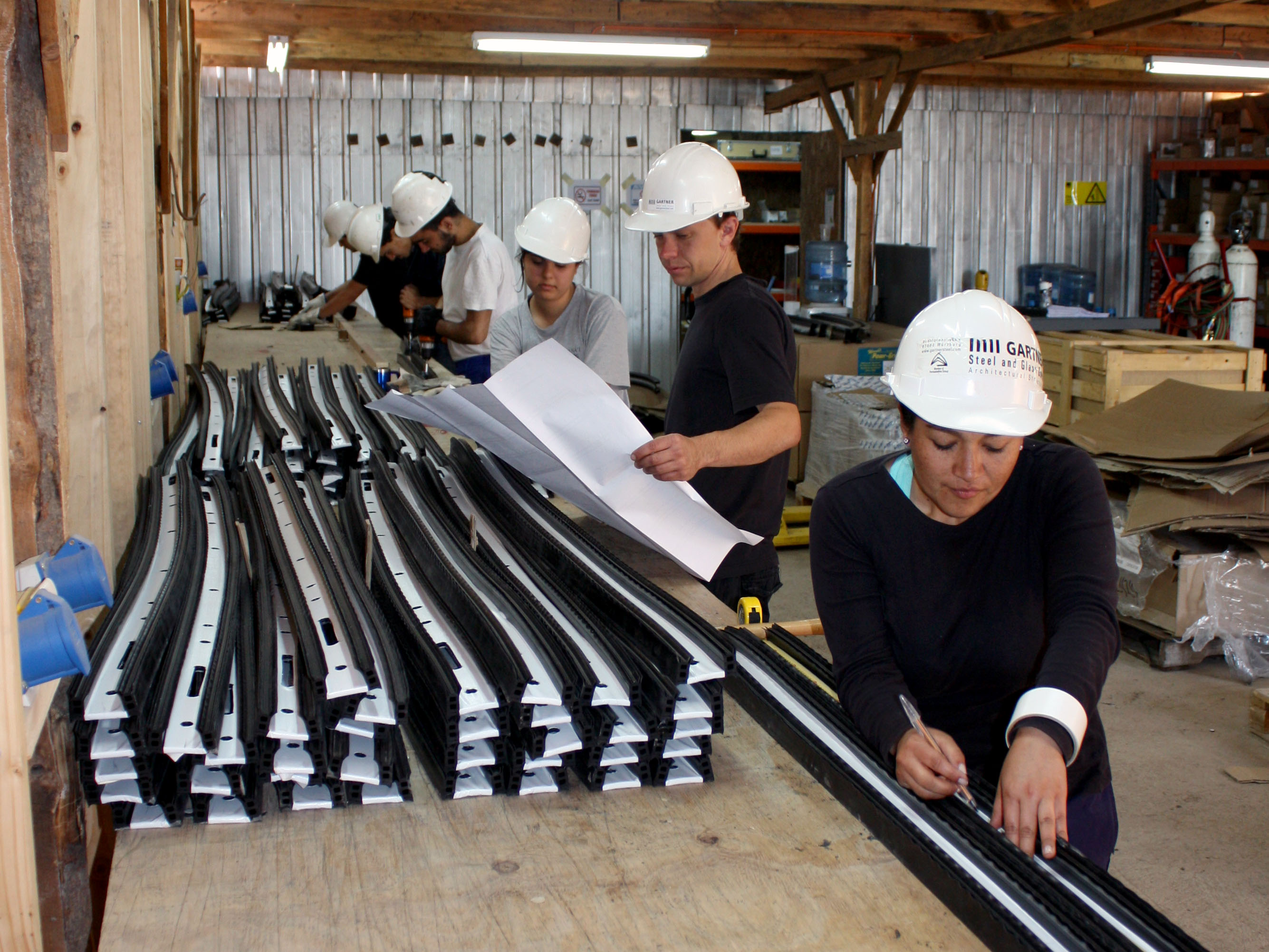 A group of international volunteers working on the preparation of the components of the superstructure.