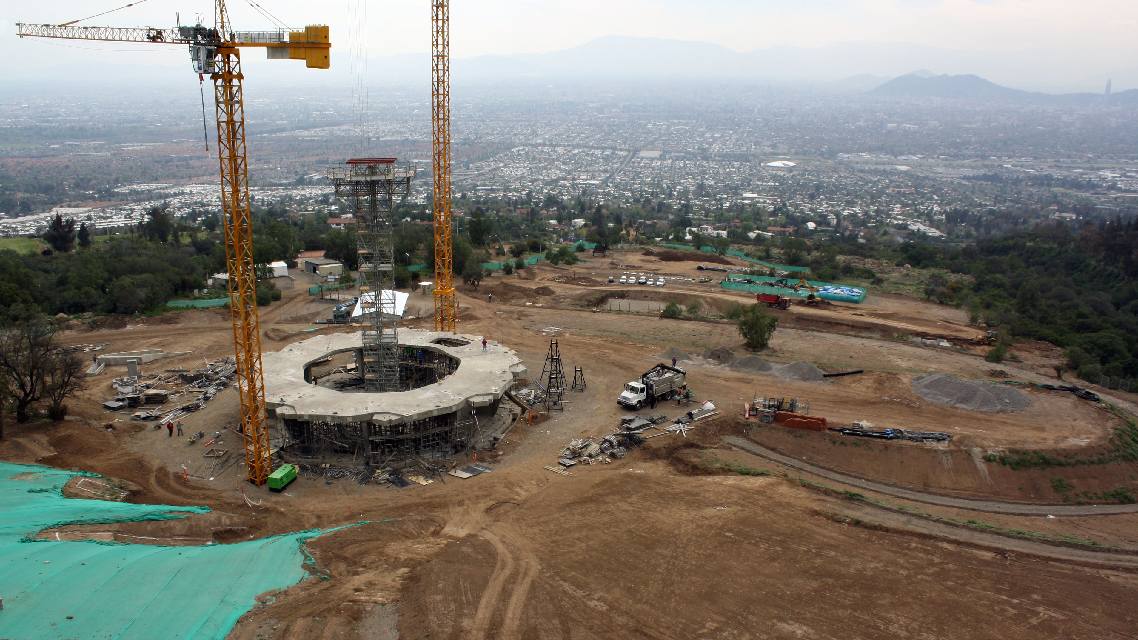View of the completed concrete work of the base of the Temple, landscaping around the Temple in progress and the City of Santiago.