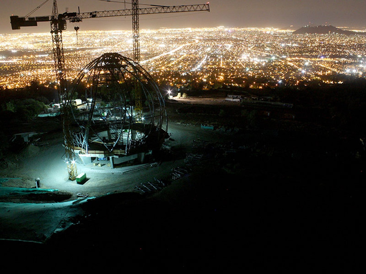 A view of the House of Worship superstructure at night, overlooking the city of Santiago.
