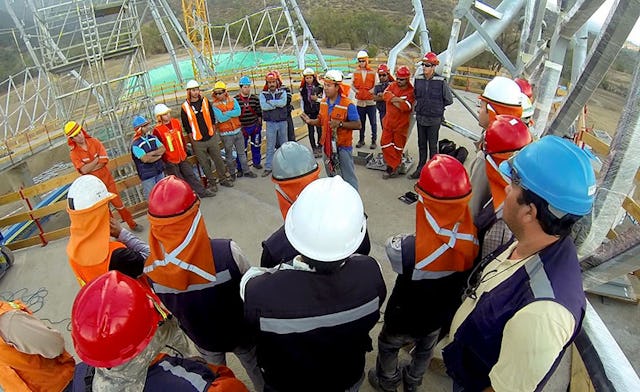 Workers gather for their daily safety briefing on the construction site in this photo from January 2014.