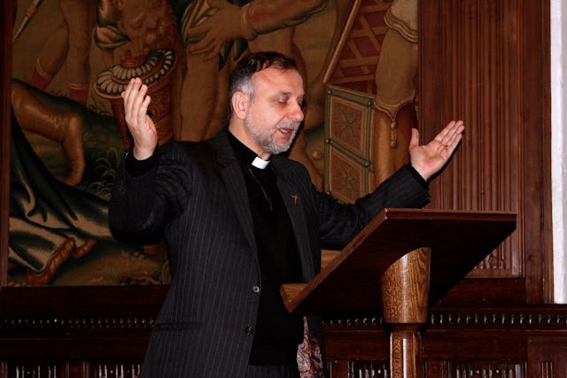 The Reverend Nadim Nassar prays for the release of Iran's seven jailed Baha'i leaders, Westminster Abbey, London, 27 May 2014. Reverend Nassar is the director and co-founder of the Awareness Foundation, which aims to empower Christians to be a counter-force of love and peace to intolerance and aggression.