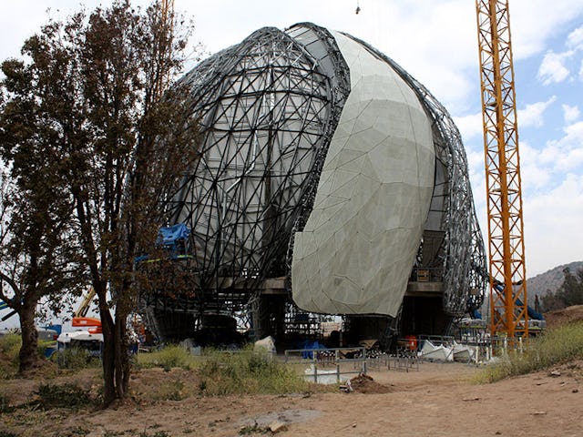 The placement of cast glass panels on the nine wing-like shells of the Baha’i House of Worship is well under way.