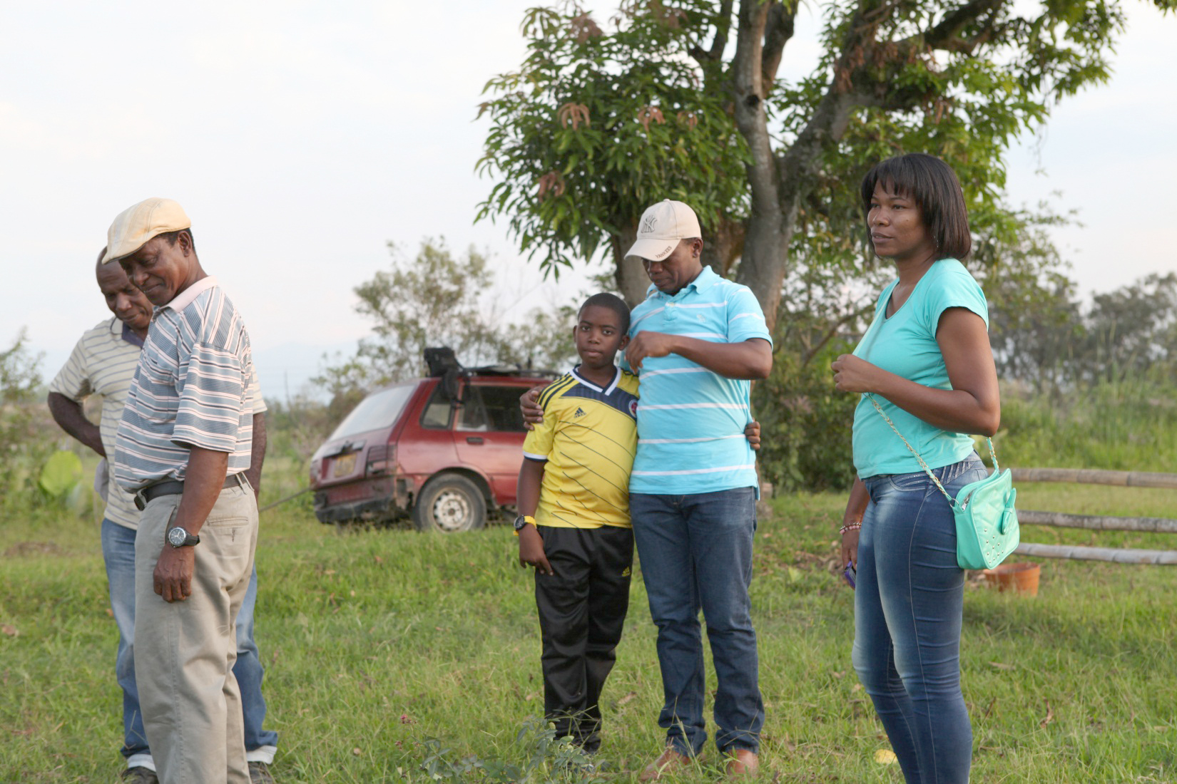 Gilberto Valencia (center right) and his son Jason (center left) after a day of planting.