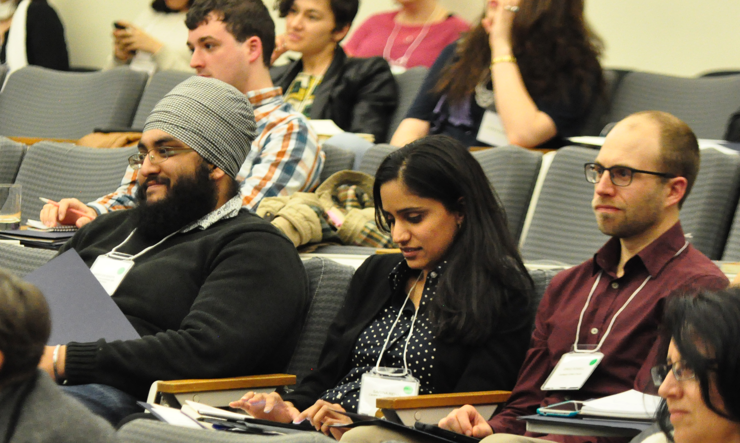 Audience members listen intently at the conference.