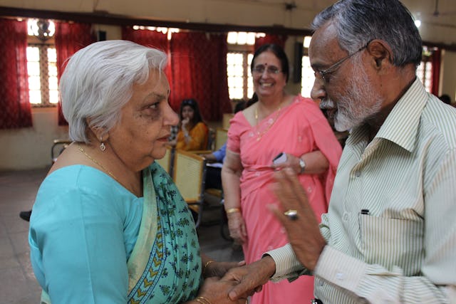 La Dra. Janak Palta McGilligan (izquierda) conversa con un miembro del público. Al fondo puede verse a la Dra. Shirin Mahalati.