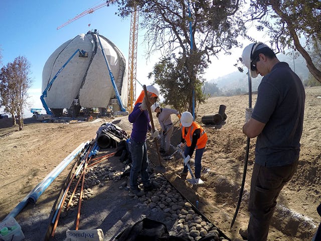 Volunteers work on landscaping and drainage system