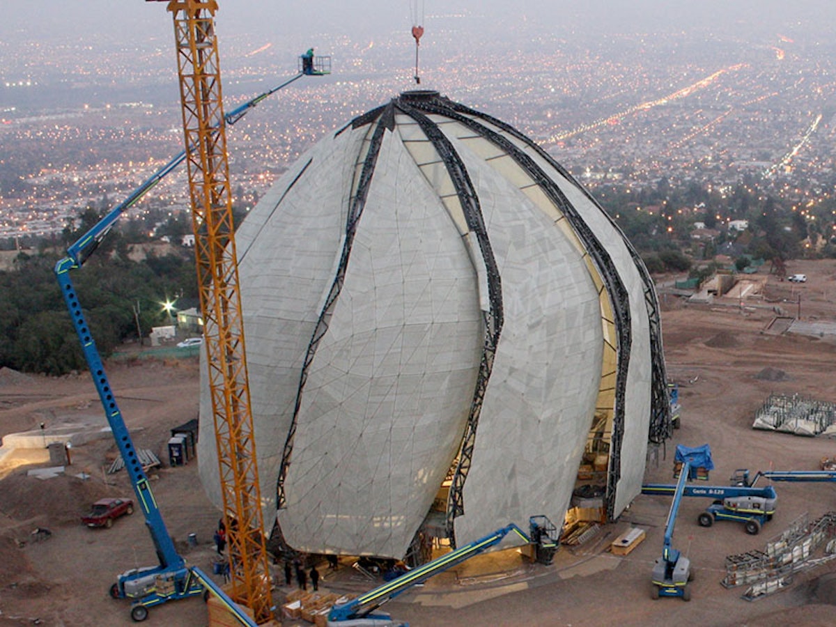 Installation of the sacred Baha’i symbol in the apex of the temple