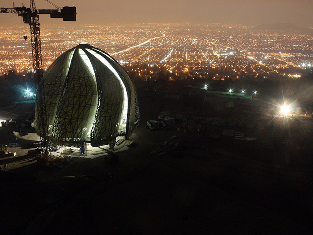In the foothills of the Andes, the Baha’i House of Worship emerges, overlooking the city of Santiago
