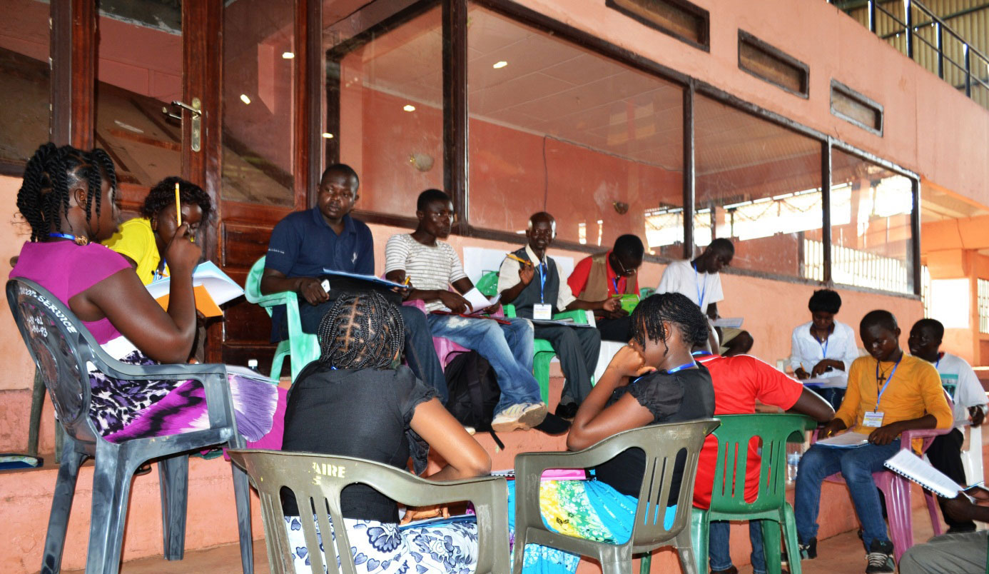 Participants study the conference materials and consult in a small group session.