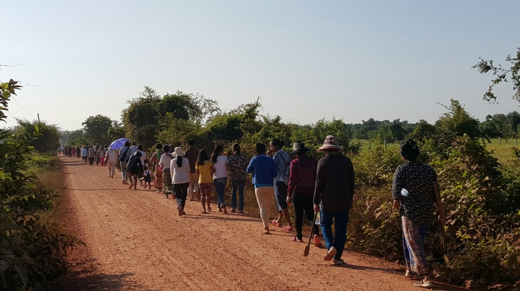 People from surrounding neighborhoods make their way to the event commemorating the groundbreaking.