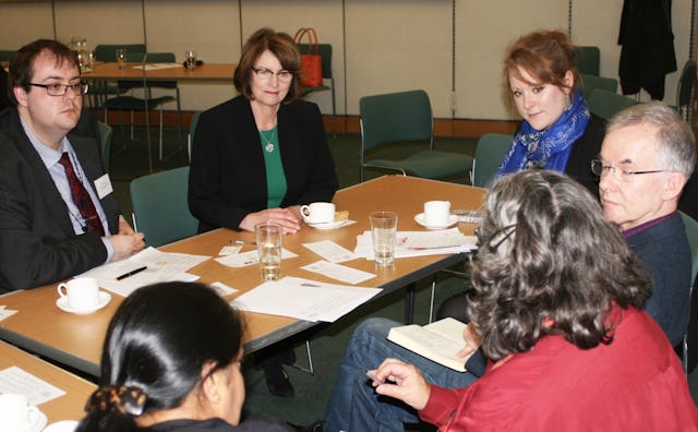 Louise Ellman (centre), the Chair of the All-Party Parliamentary Group on the Baha'i Faith, joins in a small group discussion.