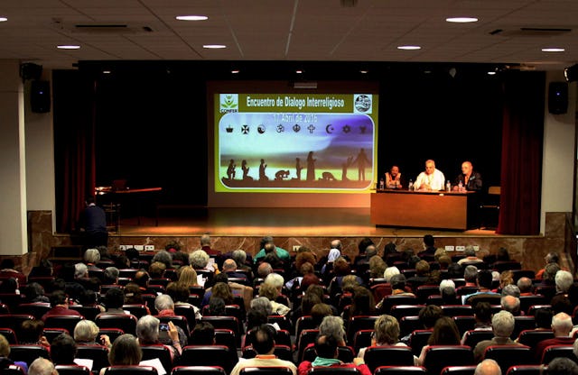 A panel of speakers at an interfaith conference titled "Interwoven by the Mercy of God" in Madrid.