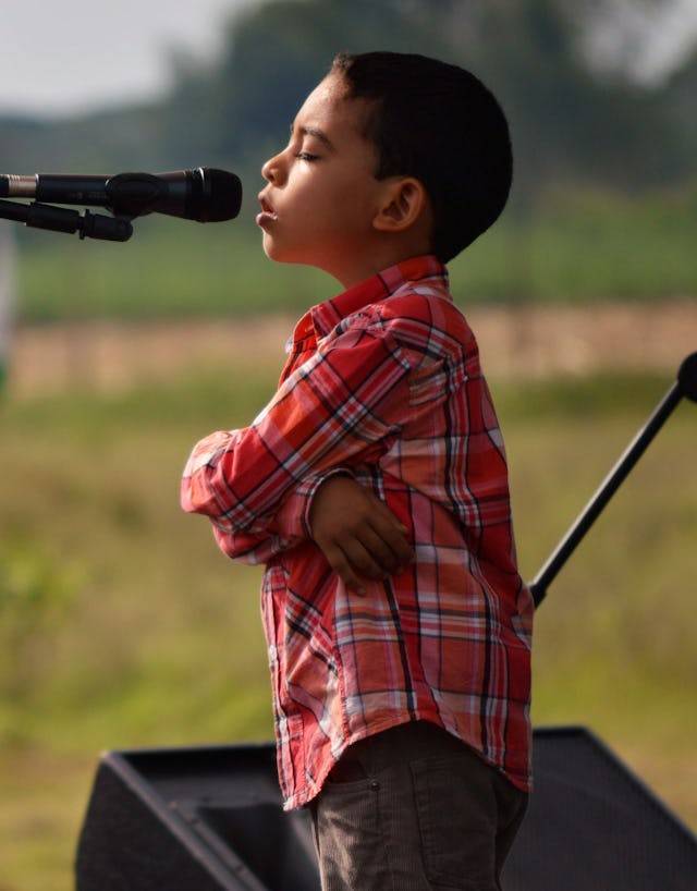 A young boy prays during the temple groundbreaking in Agua Azul on 22 May.