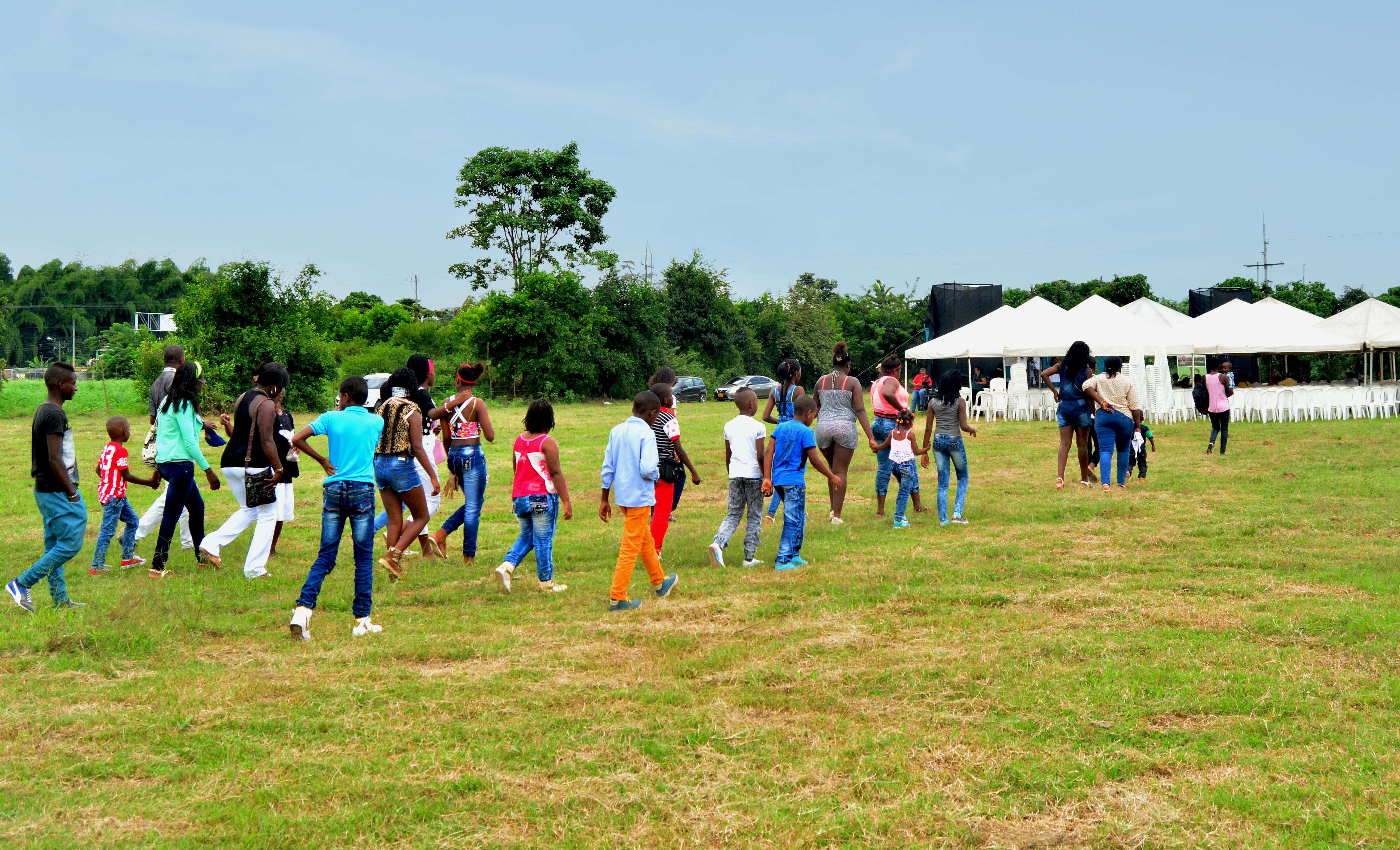 The first participants walk to the tents that were set up on the temple land. Some 700 people attended the groundbreaking commemoration.