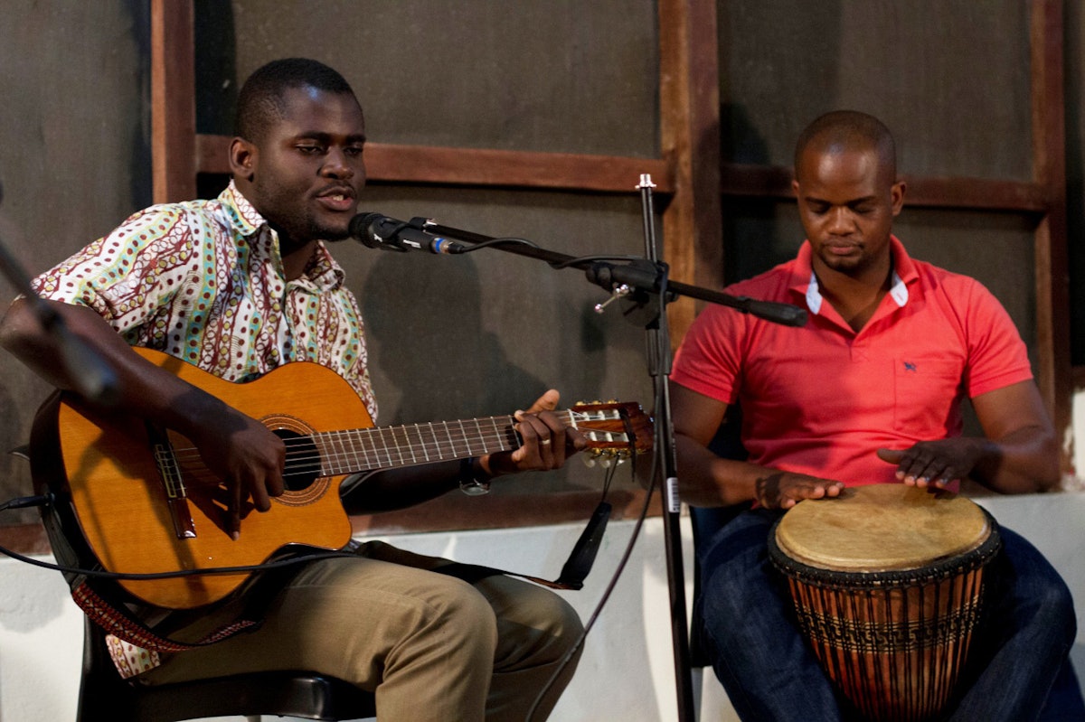 Participants practice performing songs composed at the workshop.
