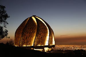A view of the Baha'i House of Worship overlooking Santiago at night.