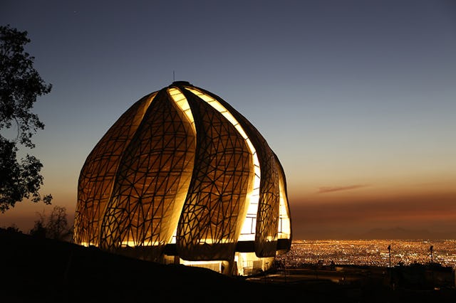 A view of the Baha'i House of Worship overlooking Santiago at night.
