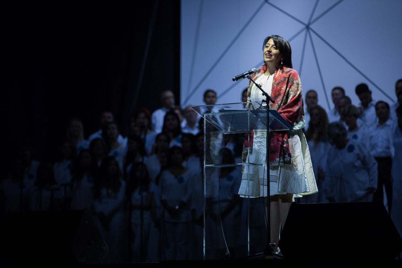 Representing the Universal House of Justice, Mrs. Antonella Demonte reads a special message addressed to the gathering at “a moment of high achievement for the Bahá’í world after much earnest striving”.