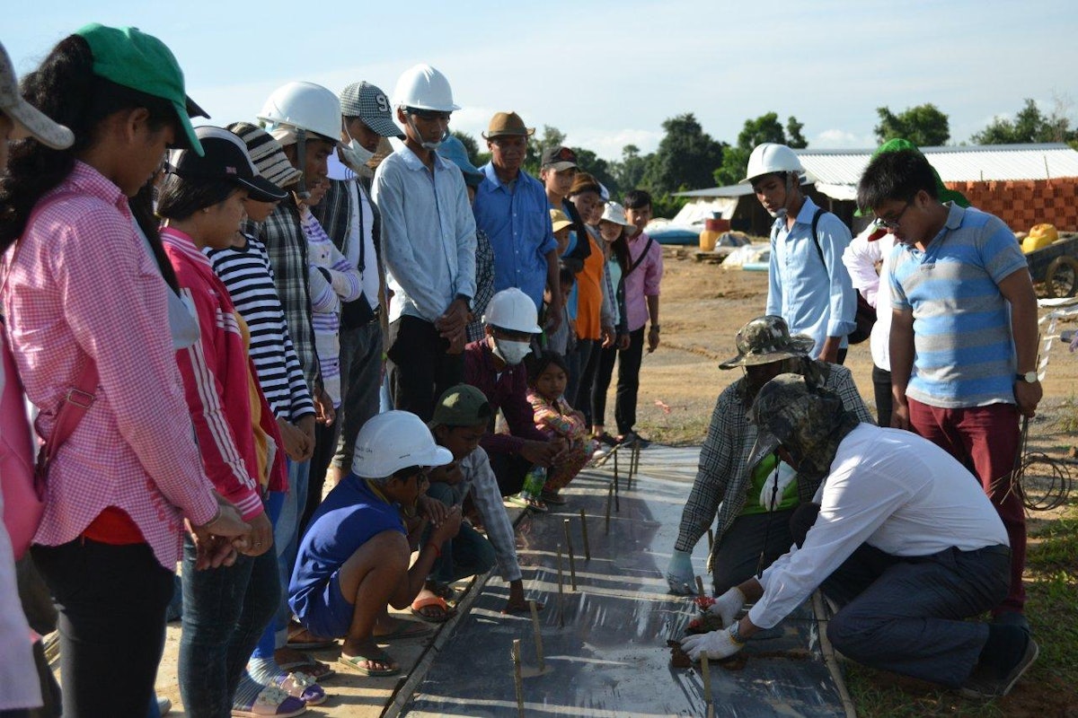 Volunteers help garden at a community gathering at the site of the House of Worship in Battambang.
