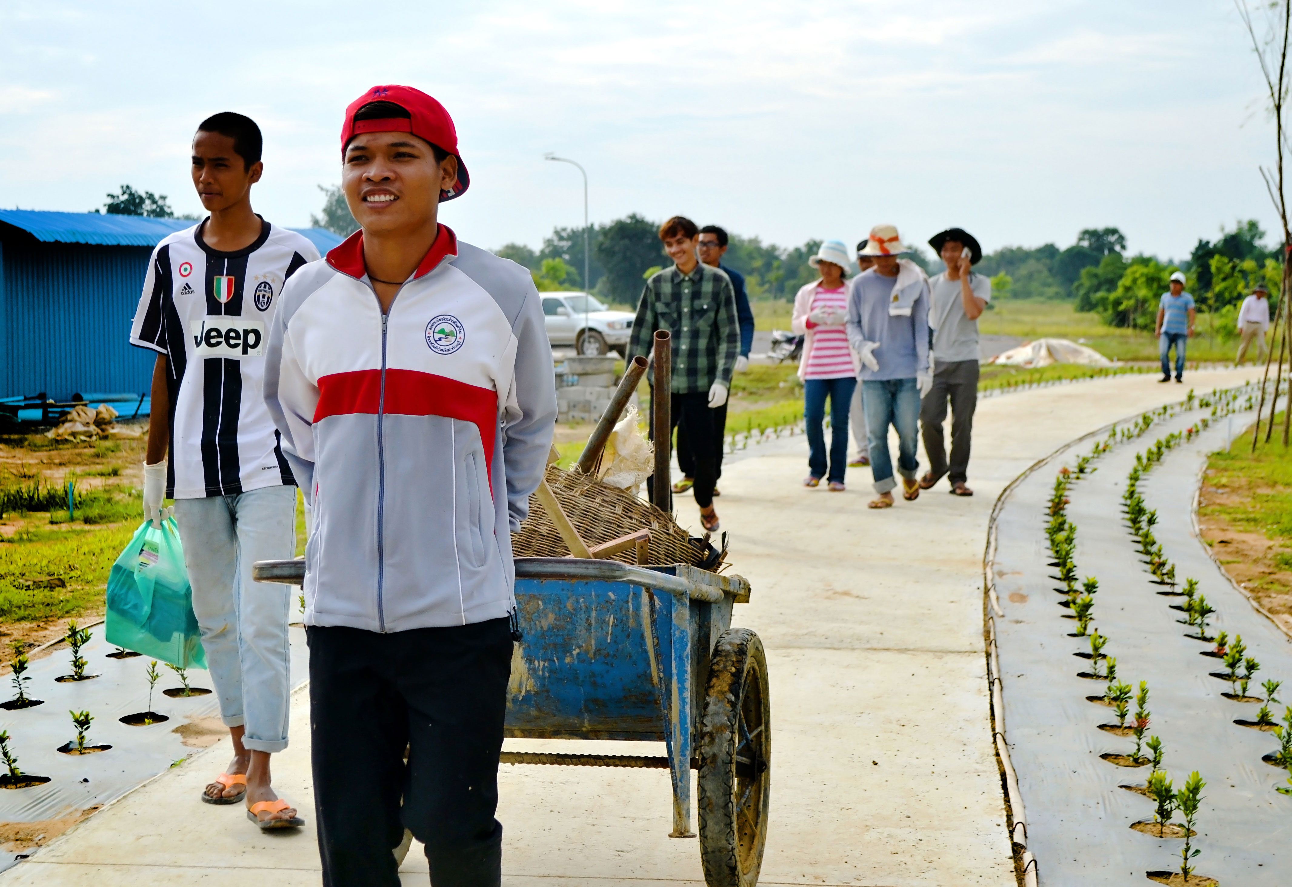Youth volunteers participate in a community gardening event at the Temple site in Battambang.