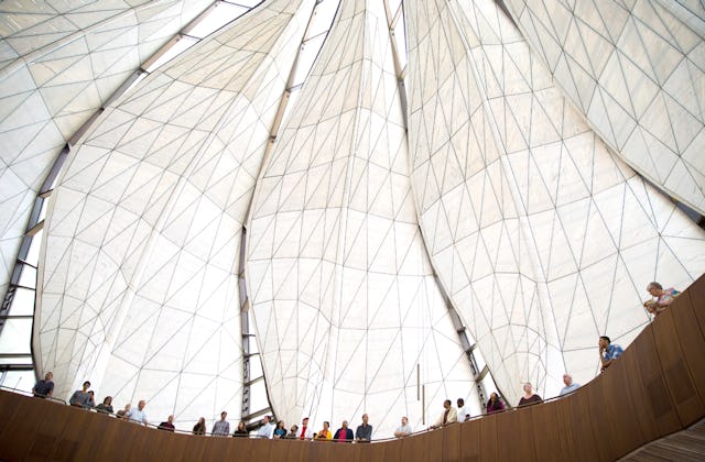 Visitors to the House of Worship in Santiago, Chile stand in the glass and marble wings of the Temple.