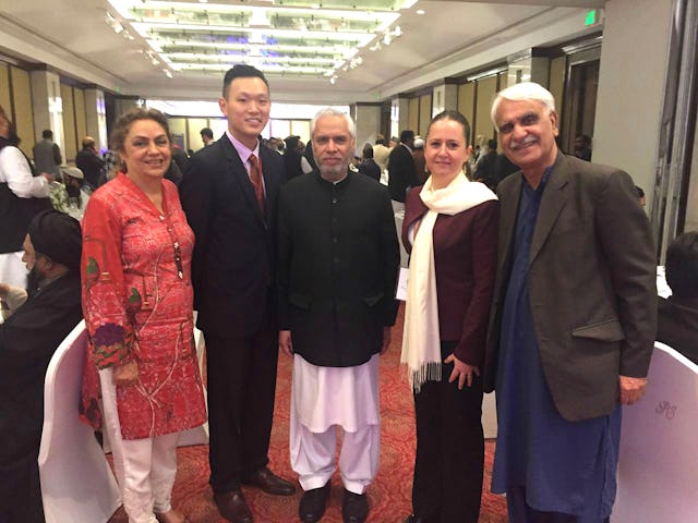 Representatives of the Baha'i International Community with the Secretary of Pakistan's Ministry of Religious Affairs (center) at the International Seerat Conference held in Lahore.