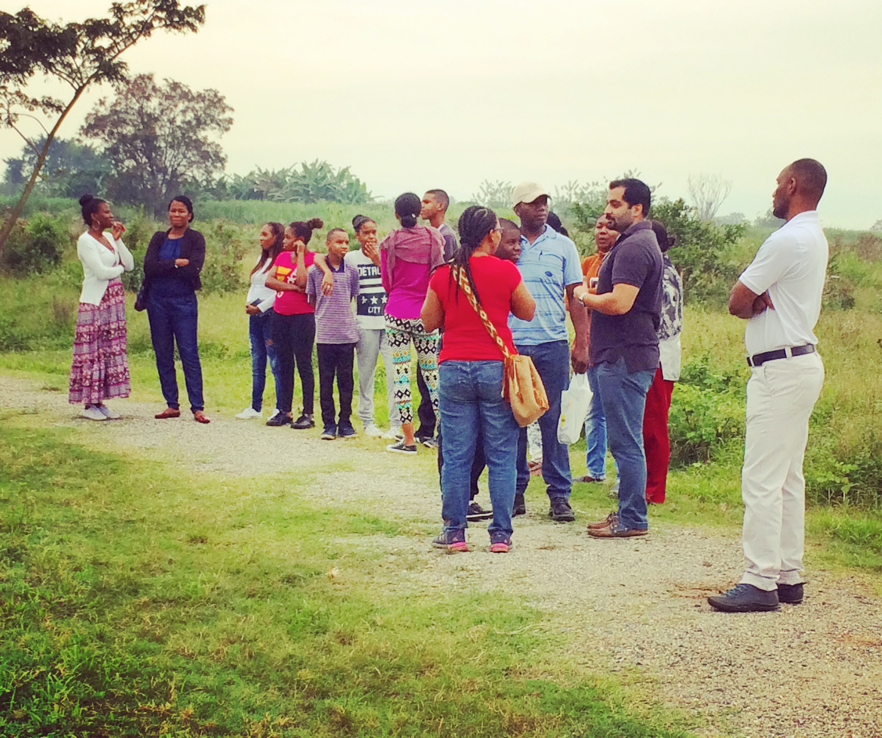 Members of the community gather on a path in the Bosque Nativo site for devotions to pray for the progress of the construction project.