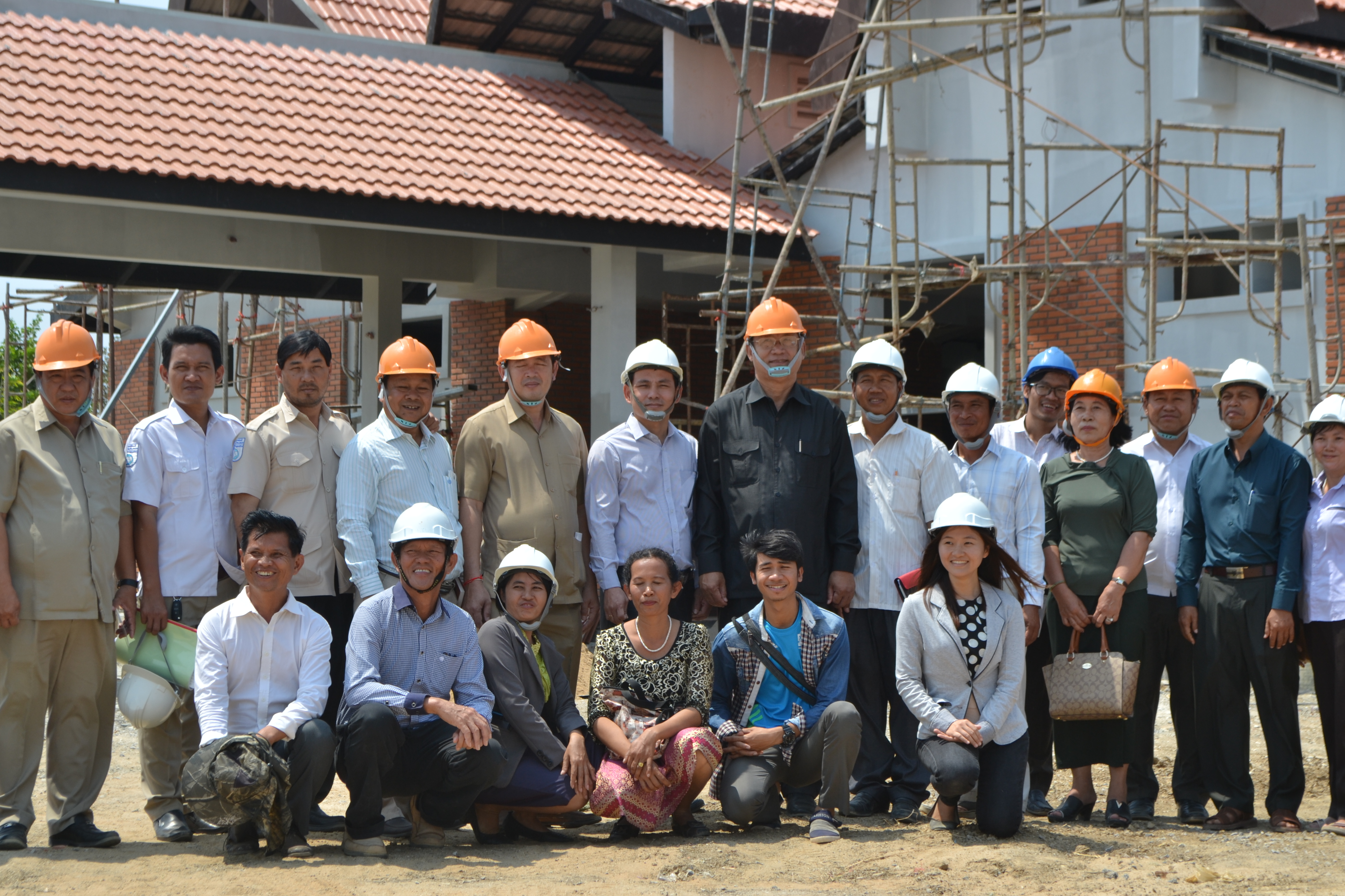H.E. Chan Sophal takes a photo with the project team and workers at the Temple site.