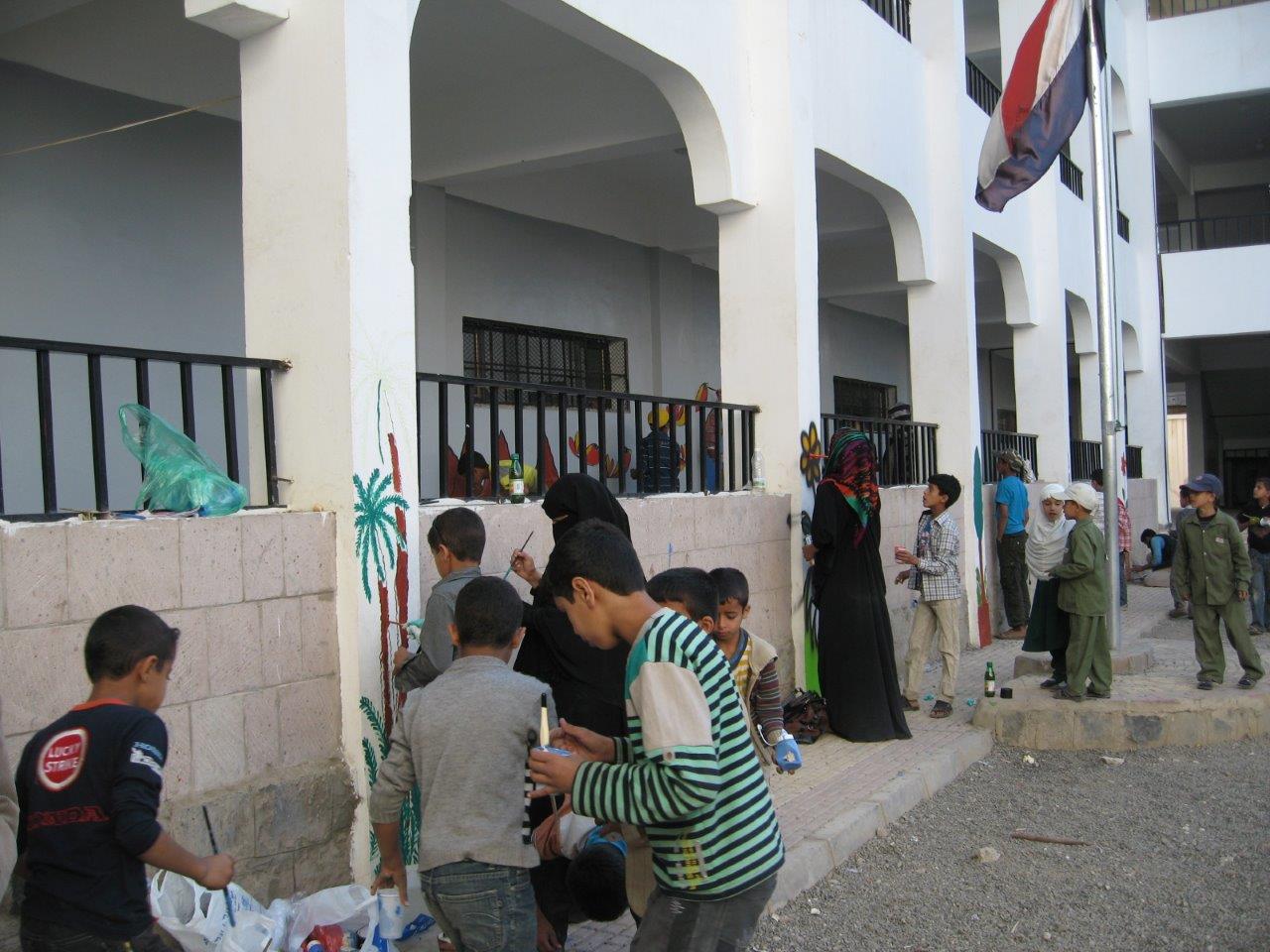 Young Baha'is and their peers engaged in a service project for their community