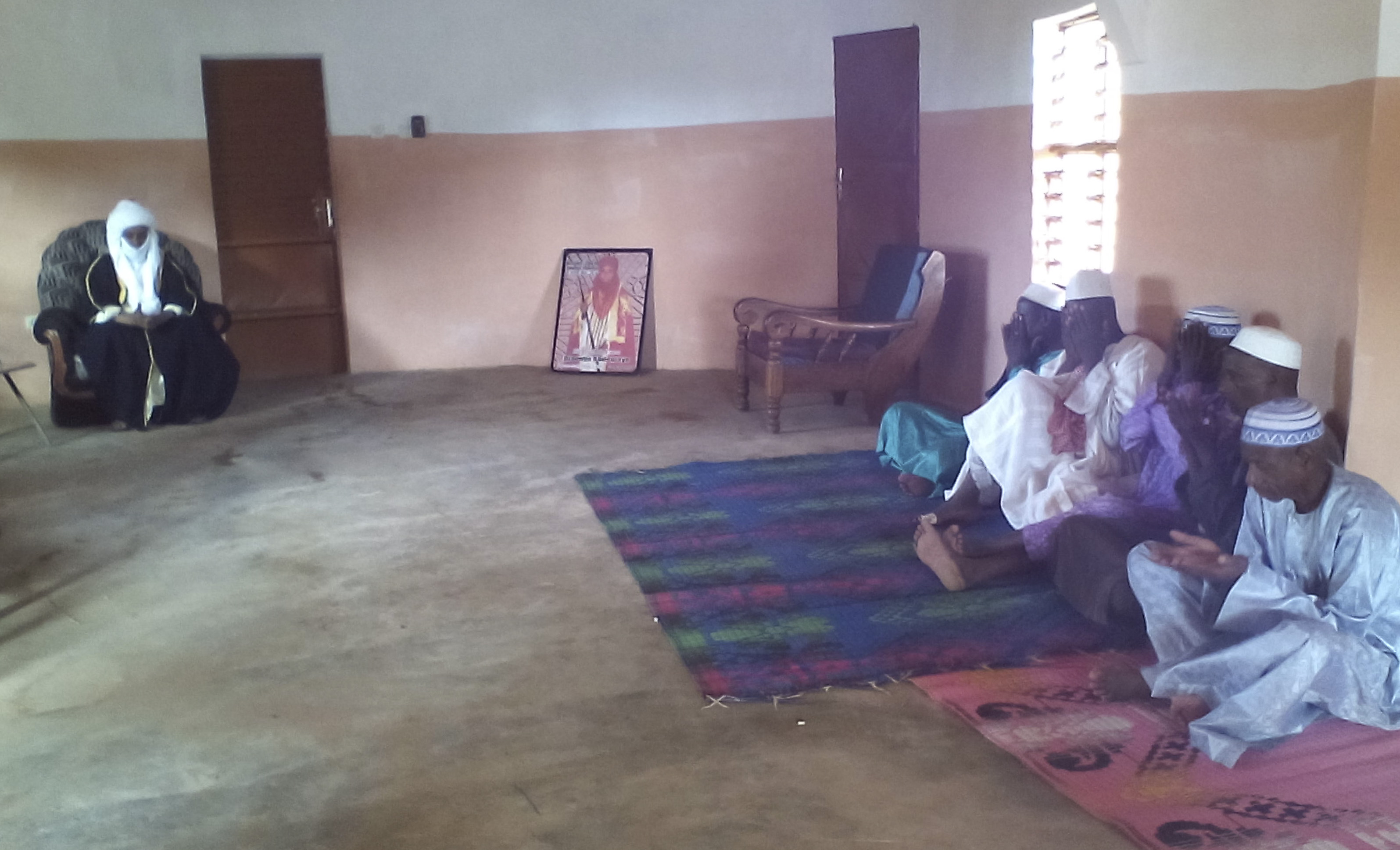 Members of the community gather for prayer in the court of High Chief Djaouga.