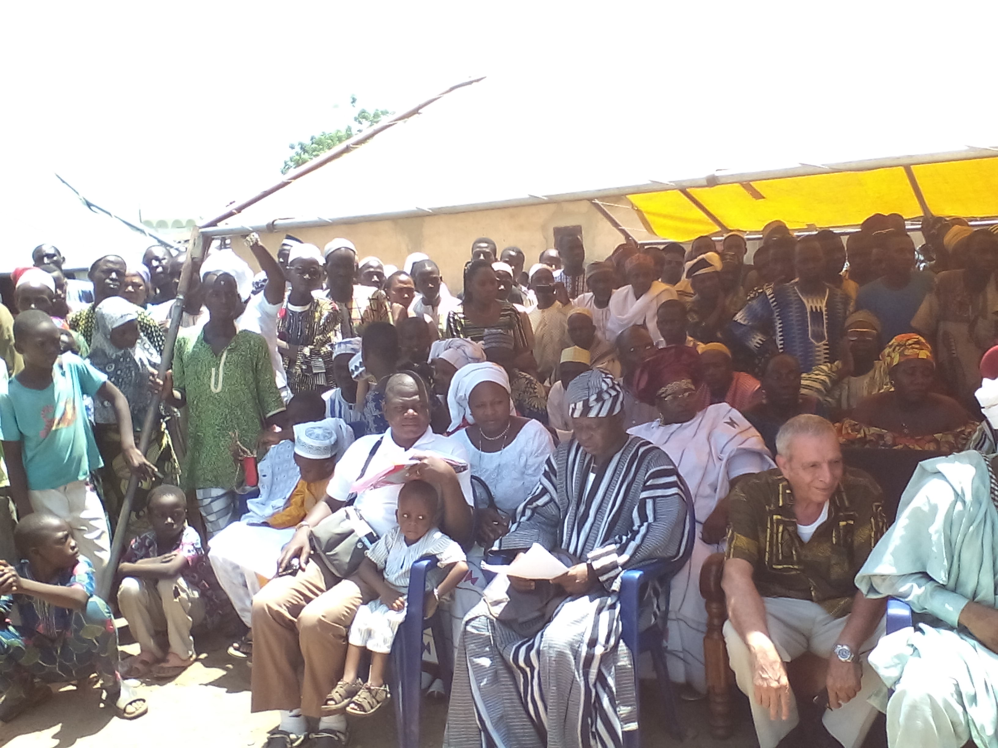 Some of the community listens to prayers being read during High Chief Djaouga's enthronement ceremony.
