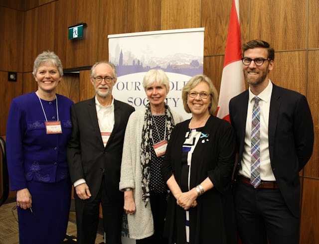 Representatives of the Baha’i community Gerald Filson (second from left) and Geoffrey Cameron (right) stand with steering committee members at the “Our Whole Society: Religion and Citizenship at Canada’s 150th,” including Elizabeth May (second from right), leader of the Green Party.