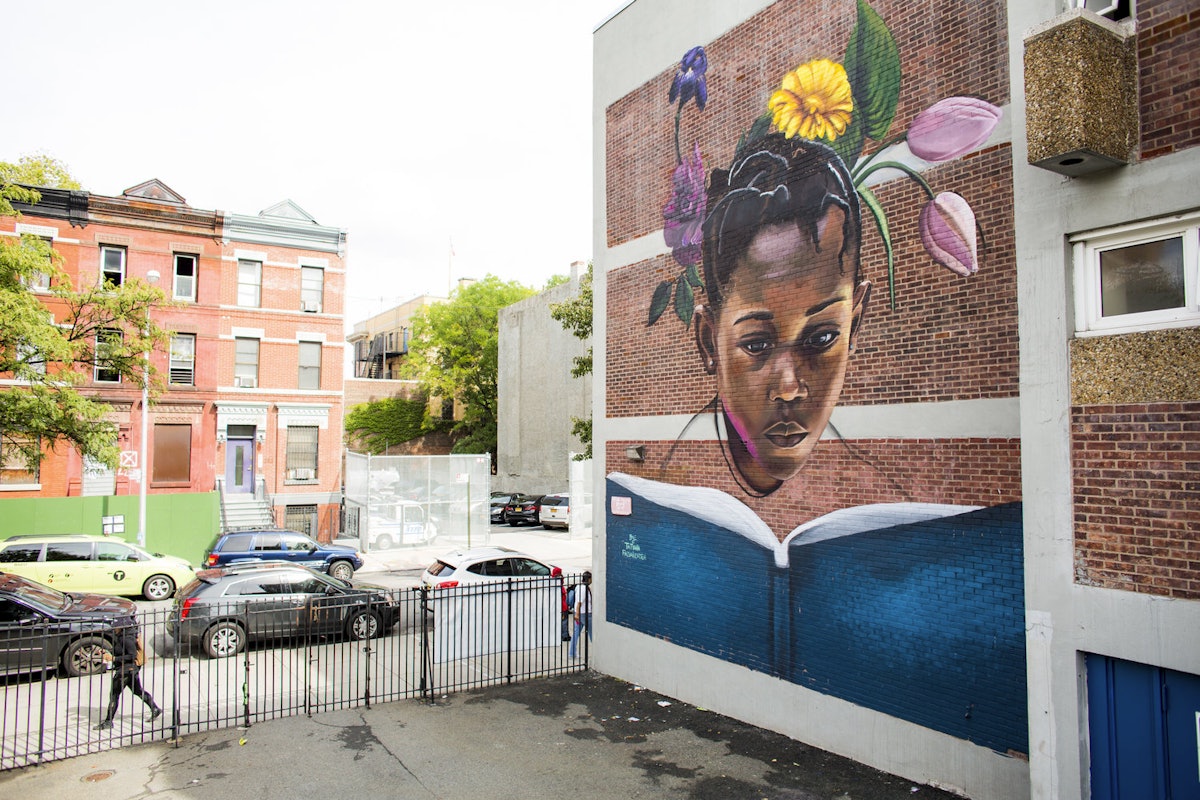 The mural “To Blossom” by artist Tatyana Fazalizadeh is located at PS92 in Harlem. It is a part of the Education is Not a Crime campaign, which raises awareness about the denial of education to Iranian Baha’i.