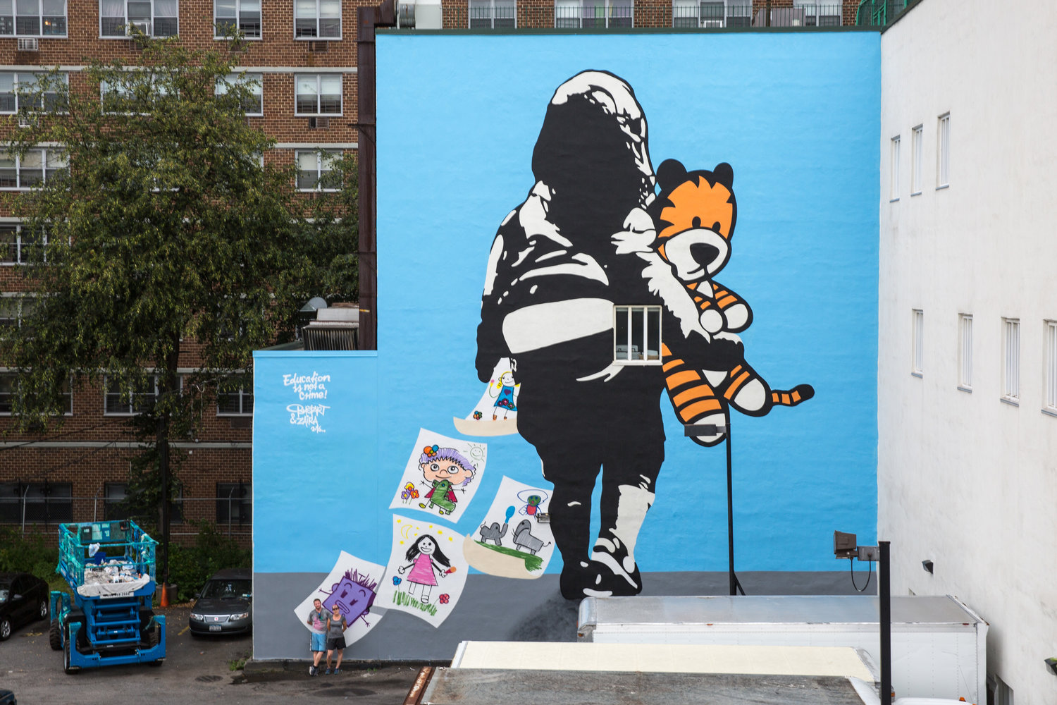 This four-story tall mural on the ABC School in Harlem by Swiss artist Bustart shows a picture of a schoolgirl with her toy tiger and a series of drawings falling away. The drawings are copies of actual drawings by the children of the ABC School. That they are falling away represents the stolen dreams of young Iranian Baha’is denied their right to go to university by their own government.