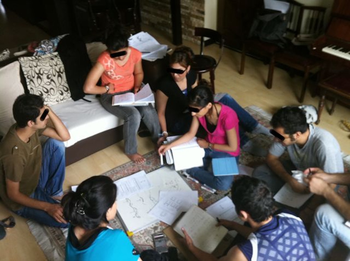 BIHE students gather in a living room to study. (Photo courtesy of the Baha’i International Community)