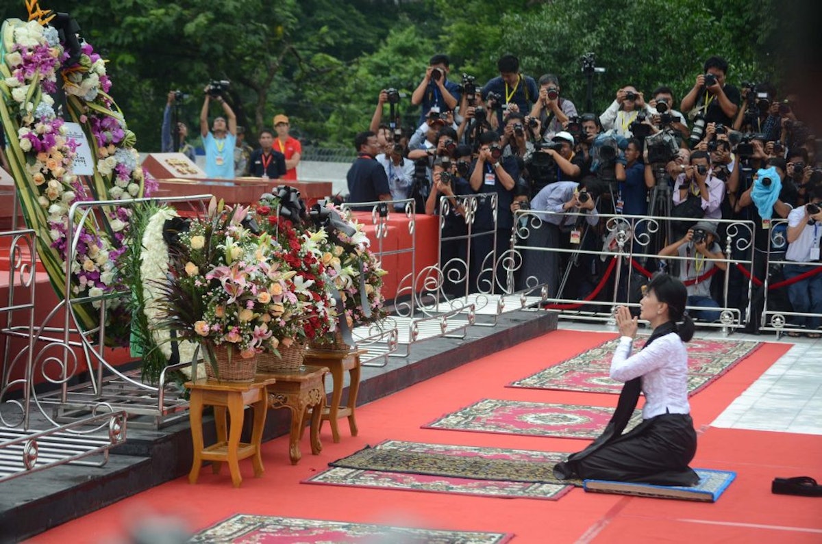 آن سانگ سو چی تاجی از گل را بر مزار نه سیاستمدار از جمله پدرش که هفتاد سال قبل به قتل رسیده بودند قرار داد. (عکس از وزارت اطلاع و اخبار میانمار)