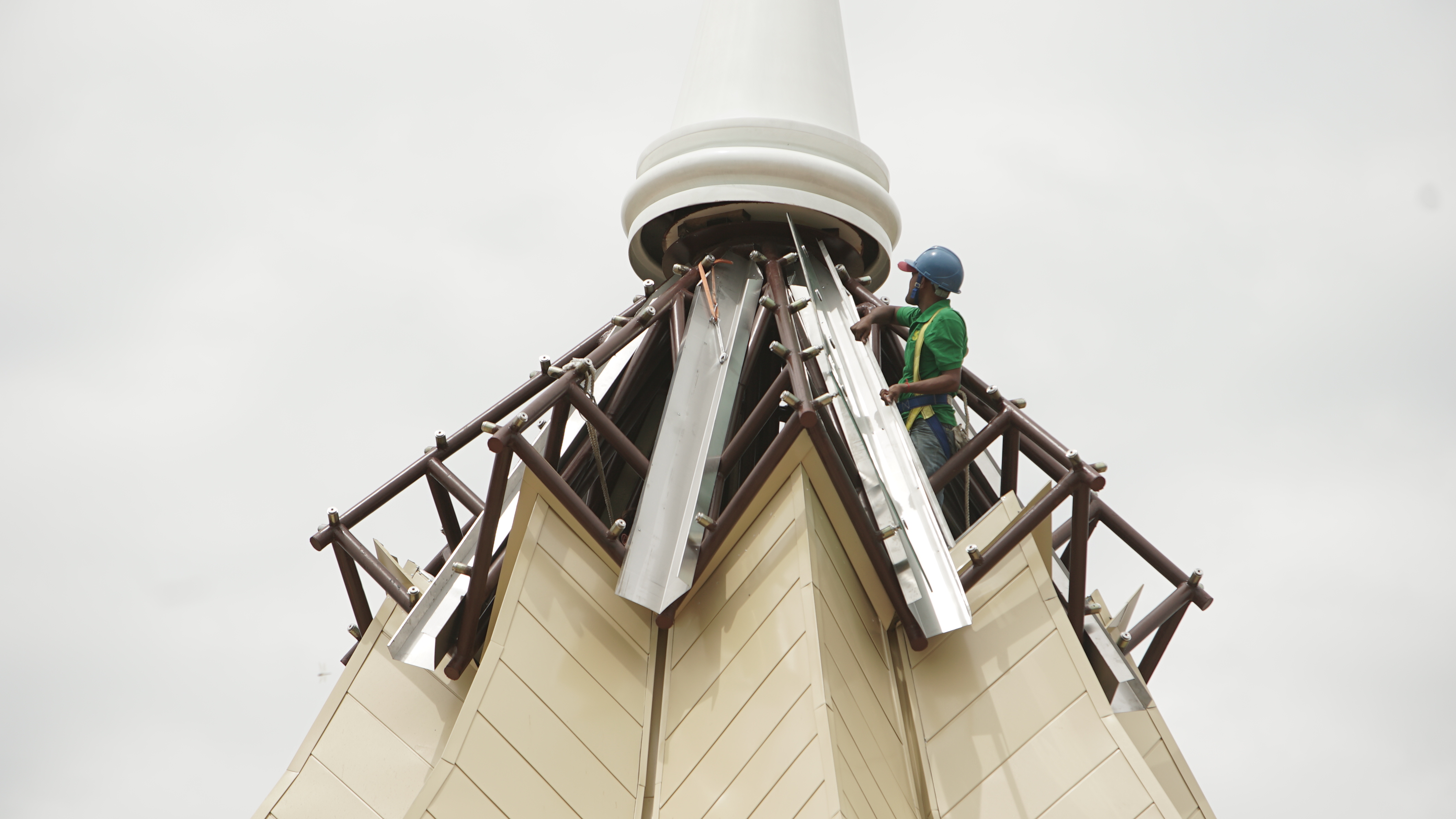 Workers finish the construction of the Temple's skylight.