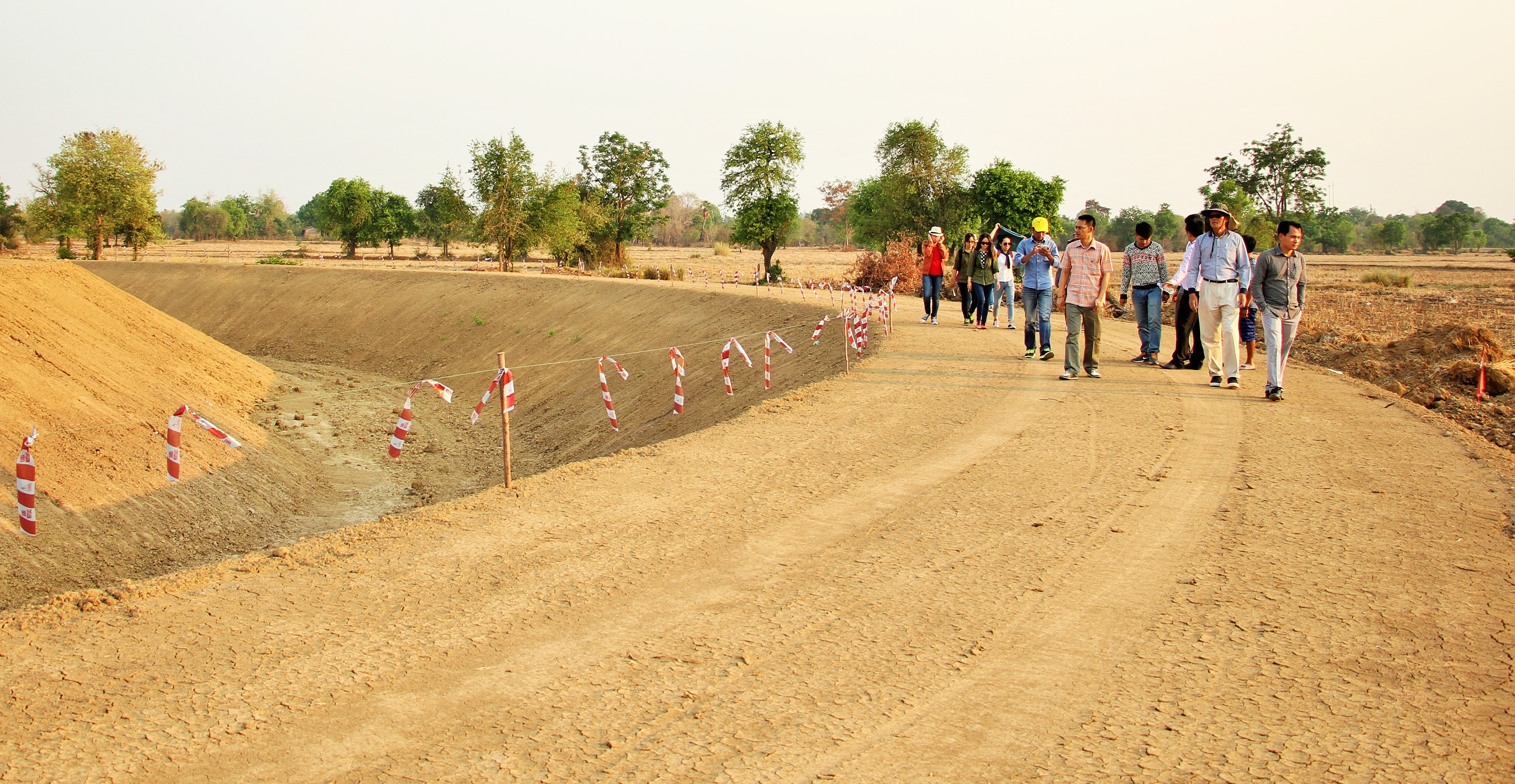The staff of ADI and the project Team stand at the site of Battambang’s Temple before construction commenced.
